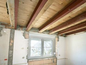 Bestehende Holzbalken müssen durch Stahlträger verstärkt werden, weil auf die Holzbalkendecke eine zementgebundene Kiesschüttung mit schwimmendem Estrich aufgebracht wird. Diese Maßnahme verbessert den Schallschutz der Geschossdecken deutlich