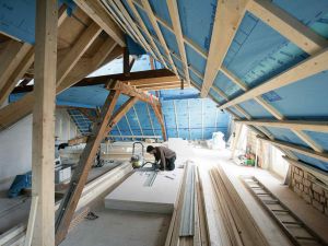 Im Zug der Erweiterung mit Gaupen wird der Dachstuhl des Querbaus erneuert. Die Dämmung erfolgt mit Zellulose.